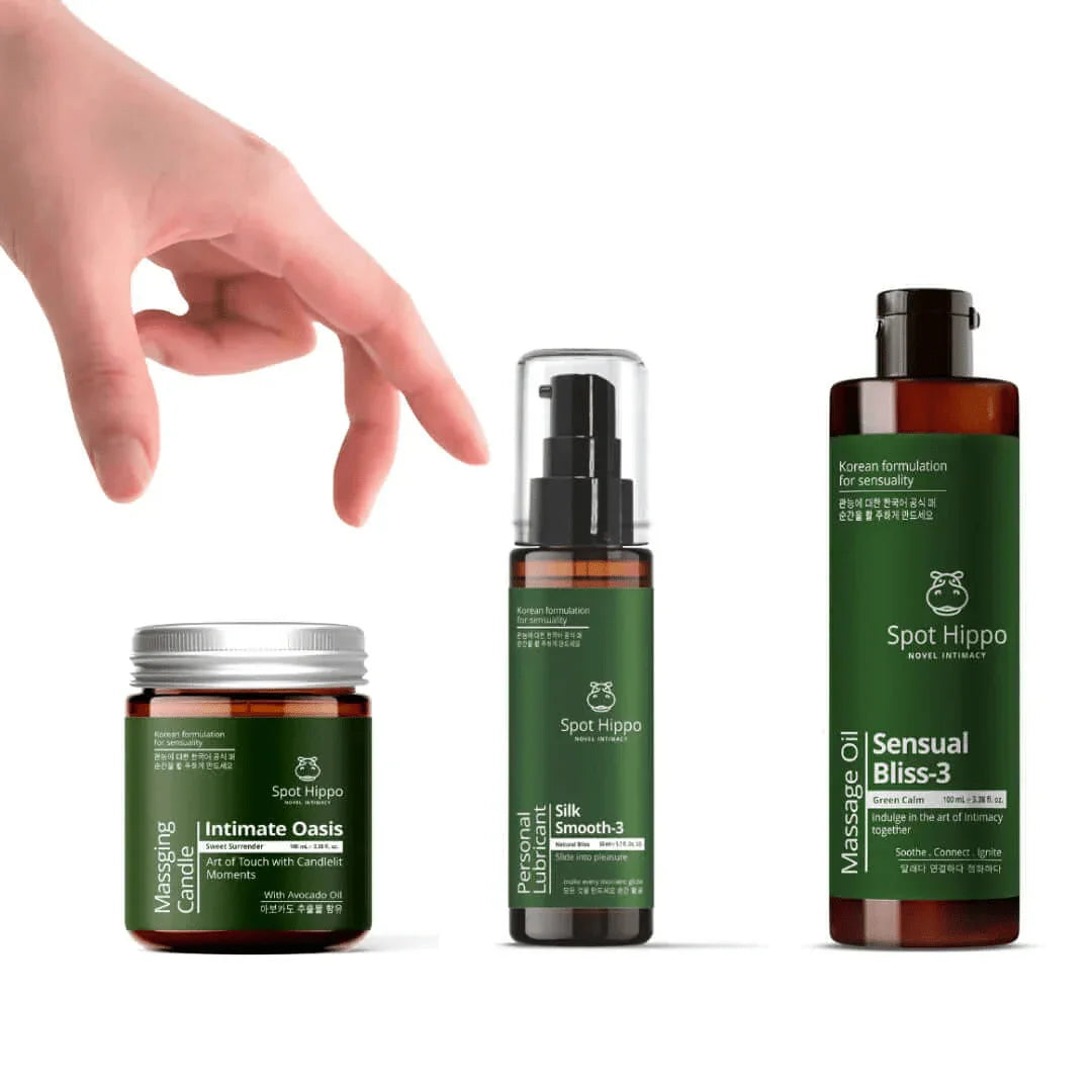 Collection of Spot Hippo products including a jar of massaging candle, personal lubricant bottle and message oil bottle on a white background